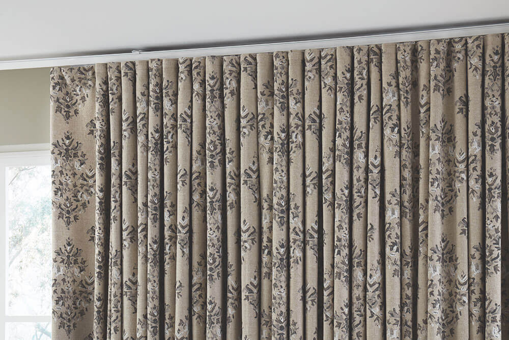 Detail of Ripplefold non-pleated drapery in a neutral floral pattern.