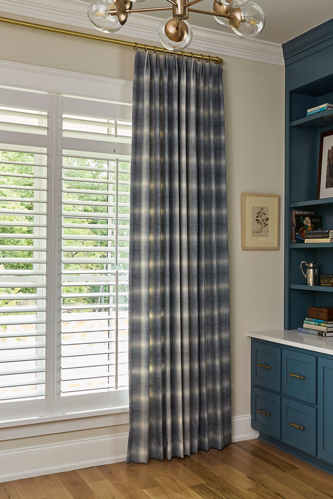 Olivia Pleat EZ Panels in a large scale blue and off-white plaid on an office window.