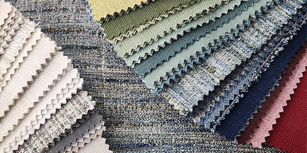 An array of colorful sustainable fabrics from the book Reclamation featuring recycled polyester fibers from Carole Fabrics.