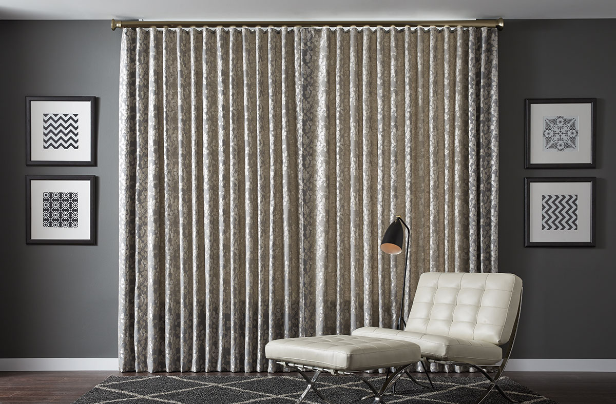 A simple modern sitting area with closed draperies.