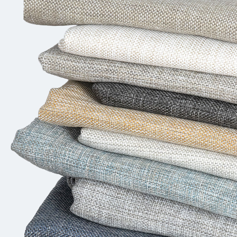 A stack of folded fabrics from the Everyday Basics Collection by CaroleFabrics.